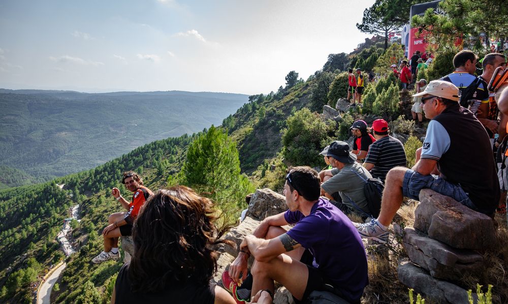 Aficionados gather on a mountainside to watch the race go past
