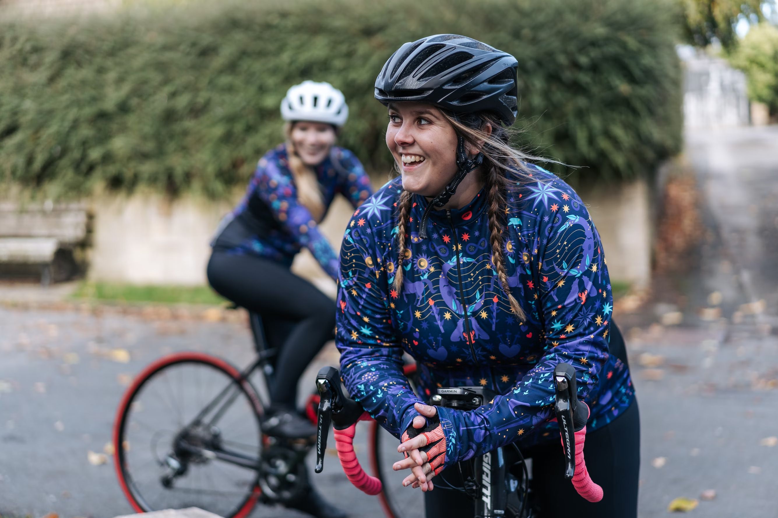 two women cyclists have a rest and a laugh