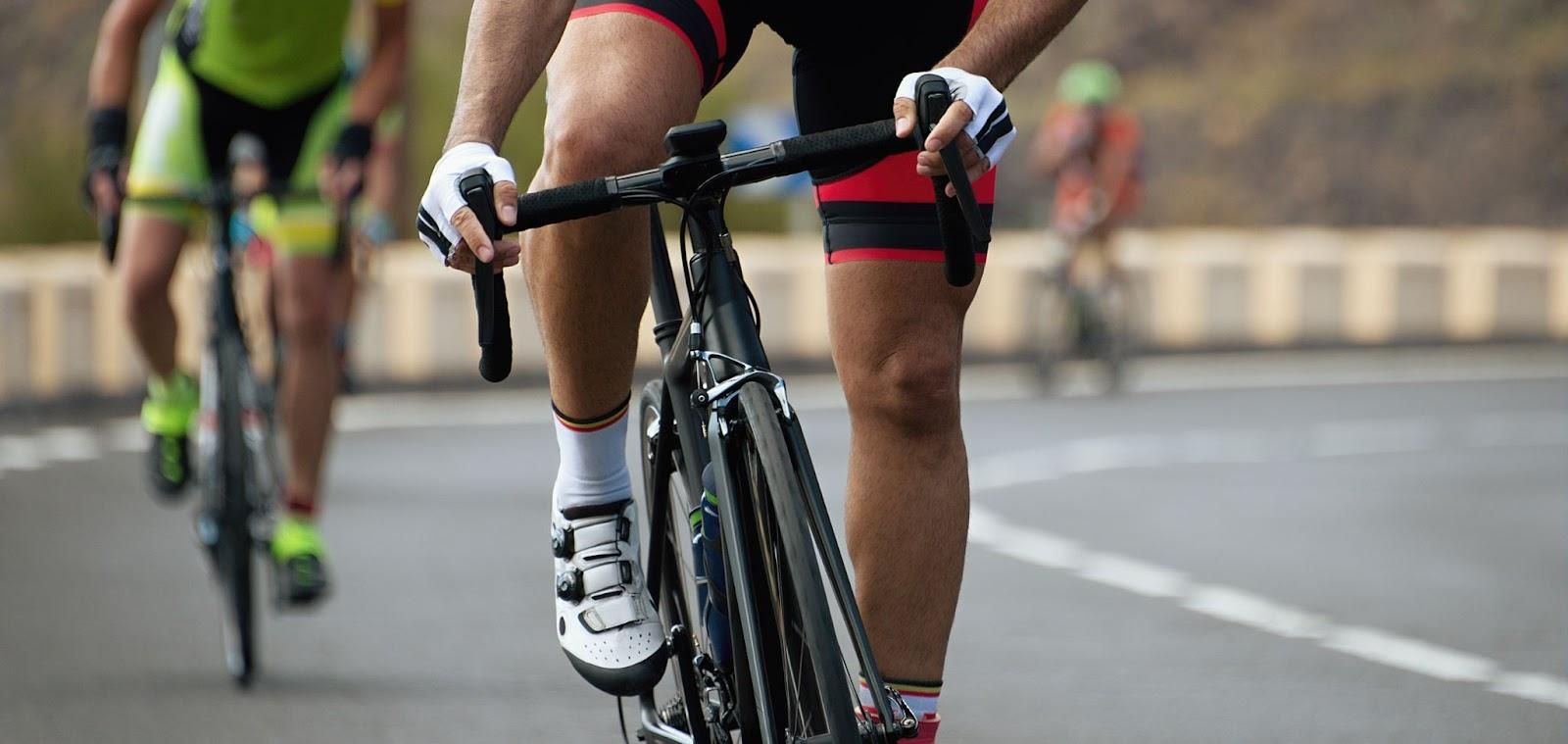 Cyclist climbing a hill being chased by other cyclists