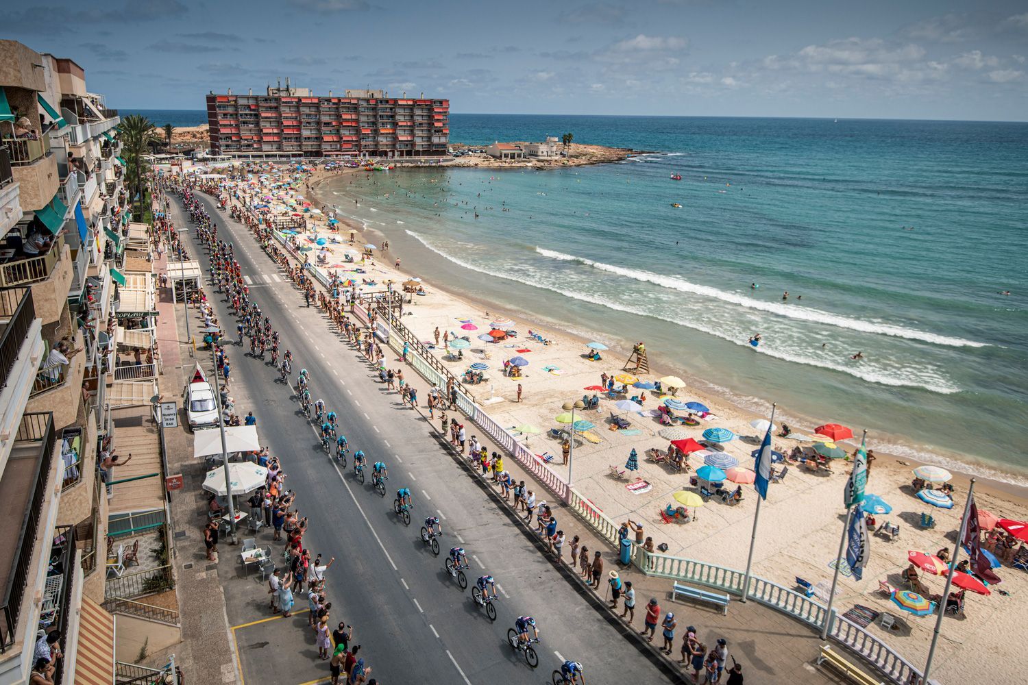 La Vuelta peloton riding along the Spanish coastline